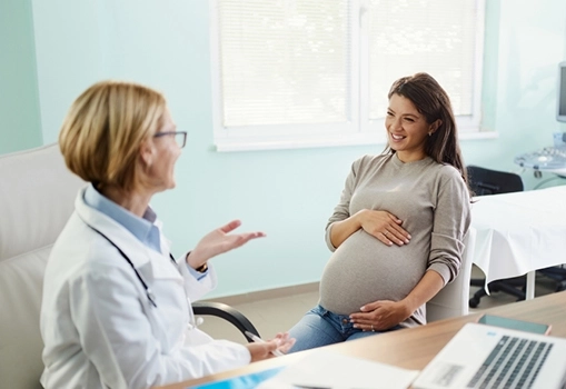 Provider consulting with pregnant patient